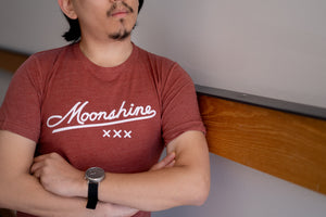 Model cross armed wearing a Clay Moonshine XXX T-Shirt