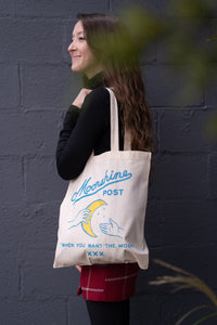 Model carrying a Moonshines Classic Tote Bag