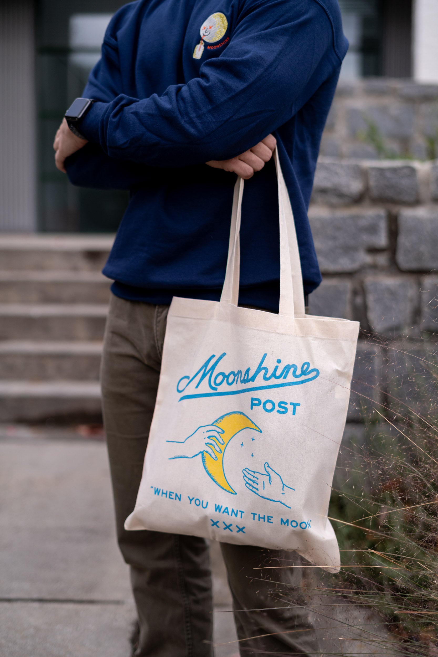 Model holding a Moonshines Classic Tote Bag