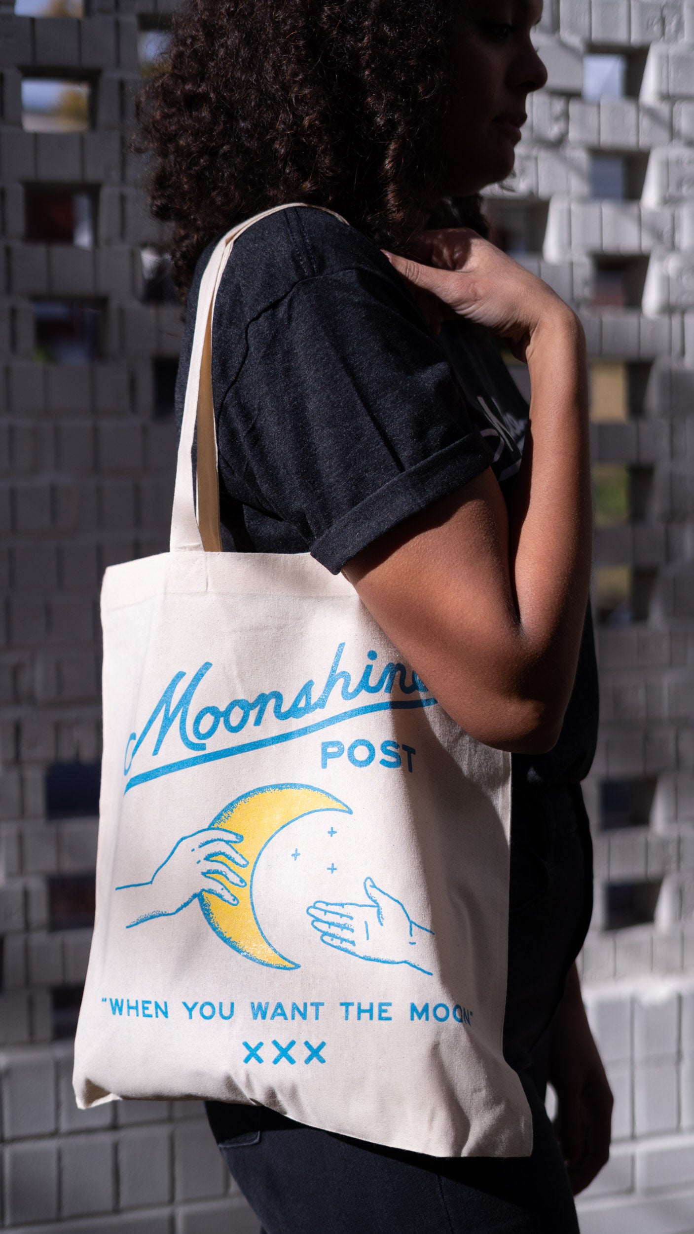 Model carrying a Moonshines Classic Tote Bag